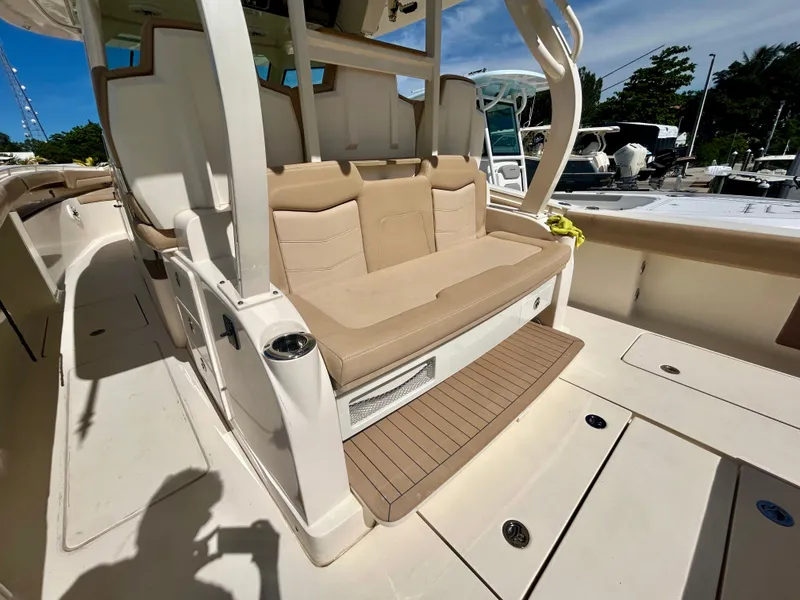 Slide: The Image of The image shows the cockpit of a 2021 Scout 380 boat with beige seating. - 6