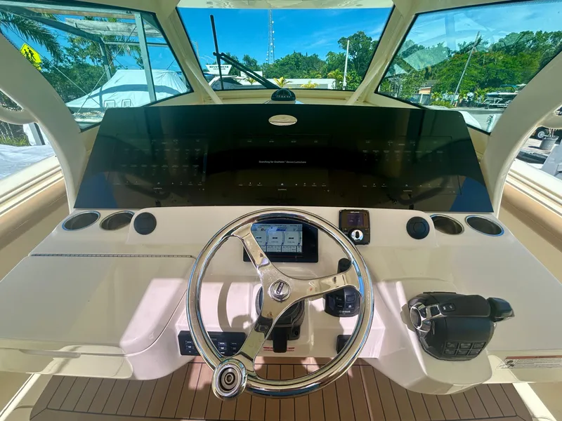 Slide: The Image of The image shows the helm of a 2021 Scout 380 boat with modern instruments. - 3