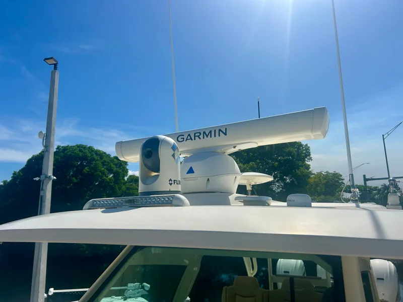 Slide: The Image of Garmin radar on a Scout 380 boat, surrounded by trees and blue sky. - 20