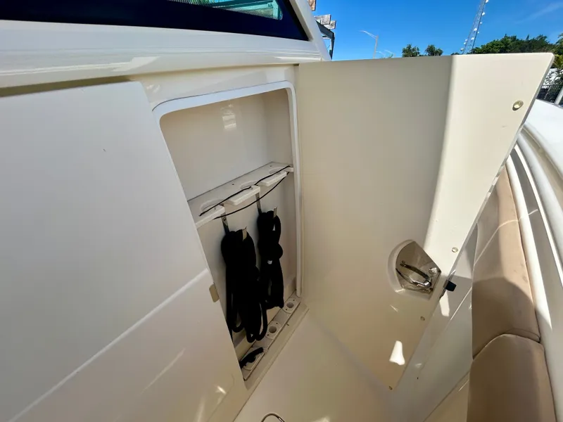 Slide: The Image of An open storage compartment on a 2021 Scout 380 boat. - 22