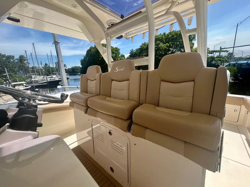 Slide: The Image of 2021 Scout 380 with beige leather seats in the cockpit, docked at a marina. - 4