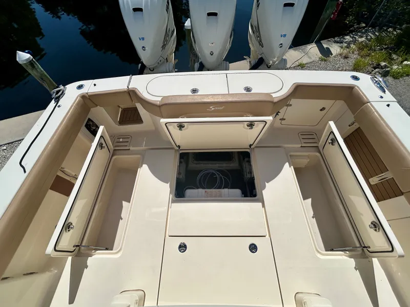 Slide: The Image of The image shows the spacious cockpit of a 2021 Scout 380 boat with storage compartments. - 9