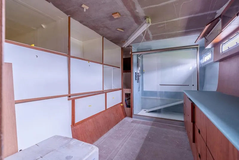 Slide: The Image of Interior of 2025 Catamaran Bloomfield 86 Motorsailor, featuring modern cabinetry and spacious layout. - 42