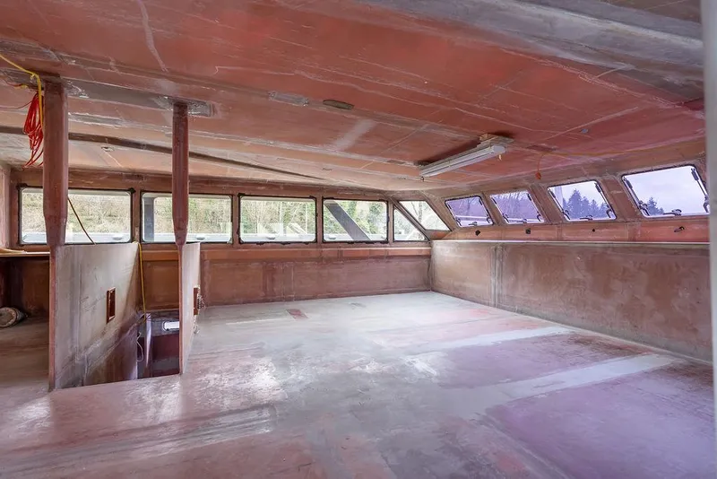 Slide: The Image of Interior of 2025 Catamaran Bloomfield 86 Motorsailor under construction, featuring spacious unfinished cabin. - 40