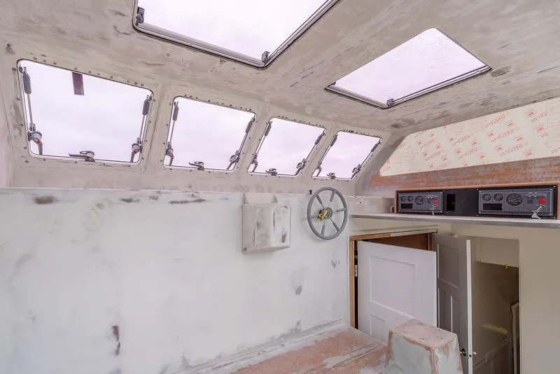 Slide: The Image of Interior of 2025 Catamaran Bloomfield 86 Motorsailor with skylights and control panel. - 17