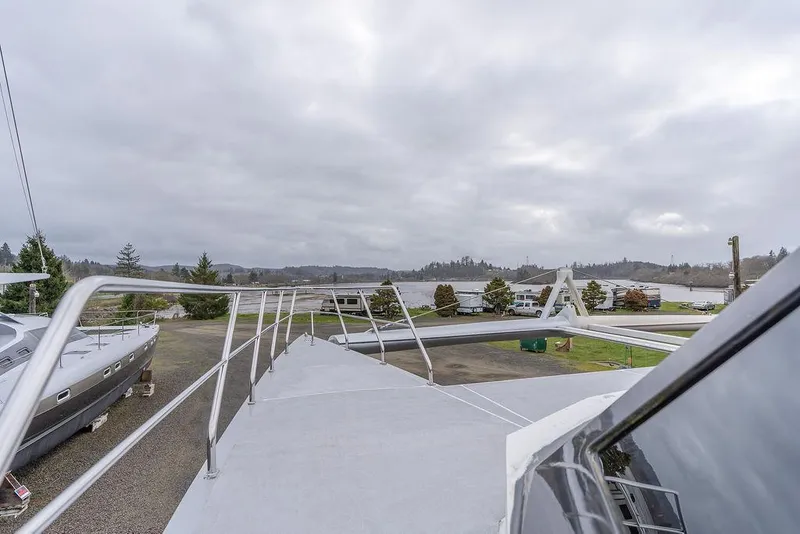 Slide: The Image of 2025 Catamaran Bloomfield 86 Motorsailor on land, showcasing deck and railing. - 31