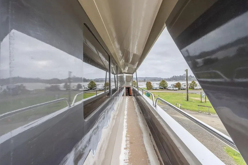 Slide: The Image of 2025 Catamaran Bloomfield 86 Motorsailor deck view, showcasing sleek design and spacious walkway. - 25