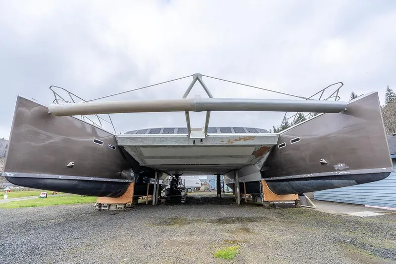 Slide: The Image of 2025 Catamaran Bloomfield 86 Motorsailor on land, showcasing its dual hull design. - 4