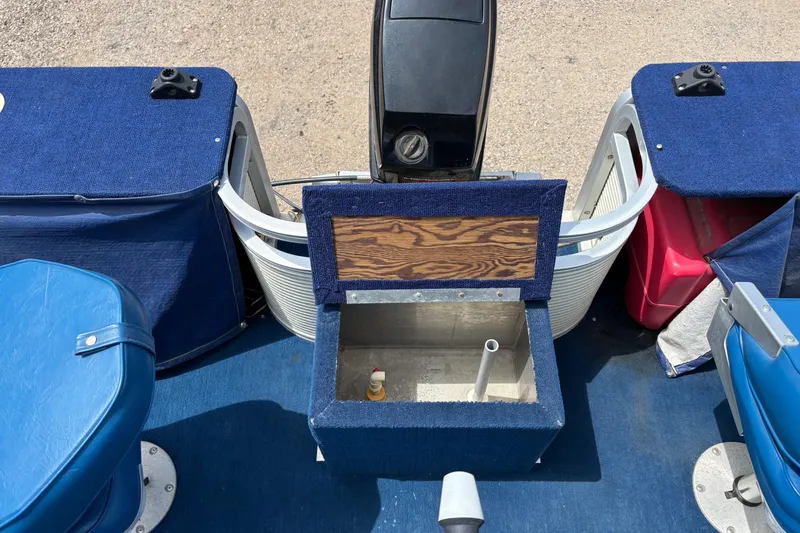 Slide: The Image of 1997 Northwood 24' Pontoon boat interior with blue seating and storage compartments. - 11