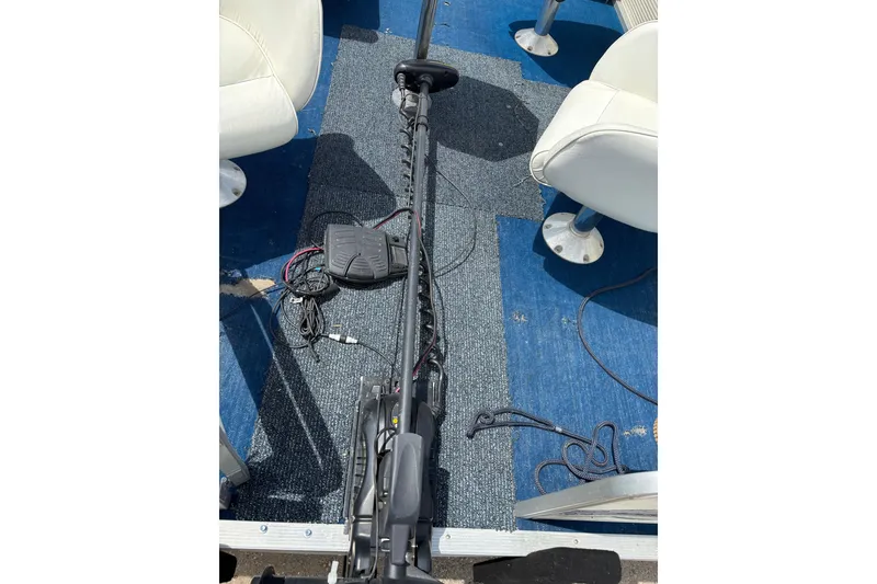 Slide: The Image of 1997 Northwood 24' Pontoon boat interior with trolling motor and blue carpet. - 8