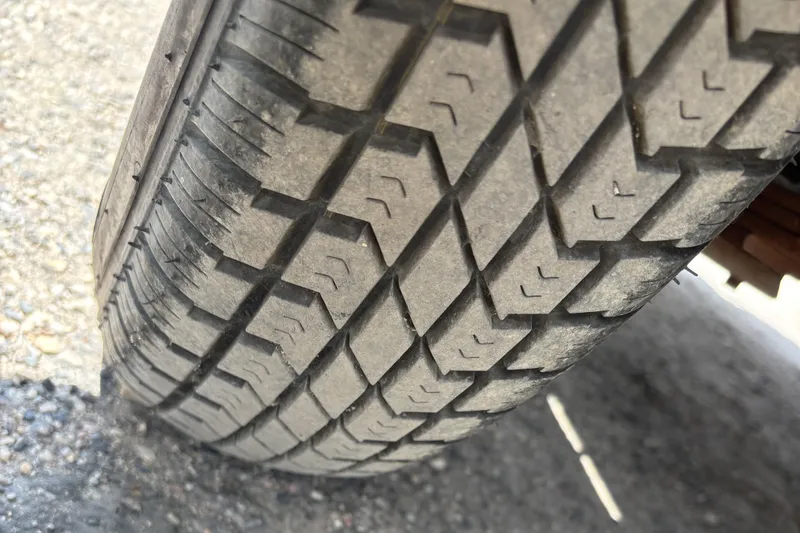 Slide: The Image of Close-up of a tire tread on a 1997 Northwood 24' Pontoon trailer. - 18