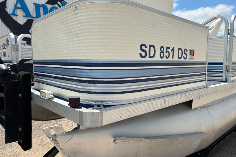 Slide: The Image of 1997 Northwood 24' Pontoon boat with registration SD 851 DS, featuring blue and white stripes. - 2