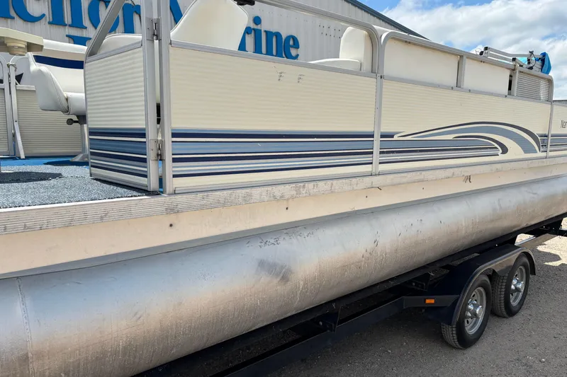 Slide: The Image of 1997 Northwood 24' Pontoon boat on trailer, featuring blue and white design. - 3
