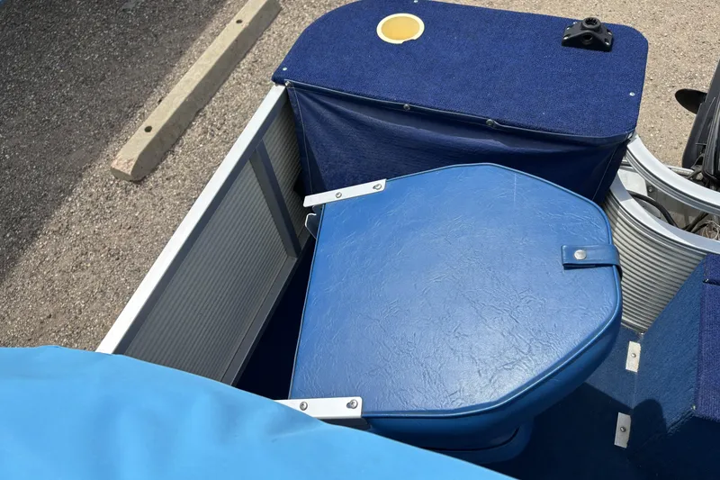Slide: The Image of 1997 Northwood 24' Pontoon boat with blue seating and storage compartments. - 10