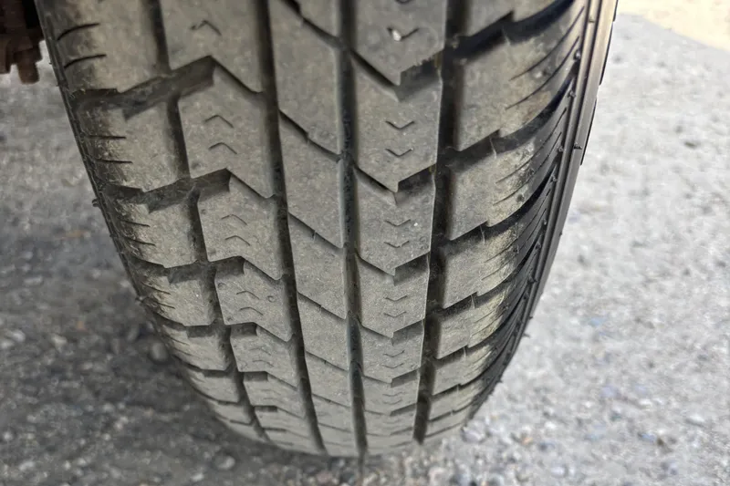 Slide: The Image of Close-up of a tire tread on a 1997 Northwood 24' Pontoon. - 19