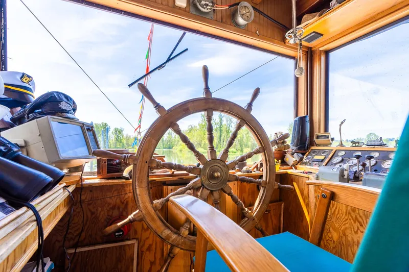 Slide: The Image of Pilot house of 1990 Custom Howdy Eidelman Sternwheeler, featuring wooden steering wheel and navigation equipment. - 39