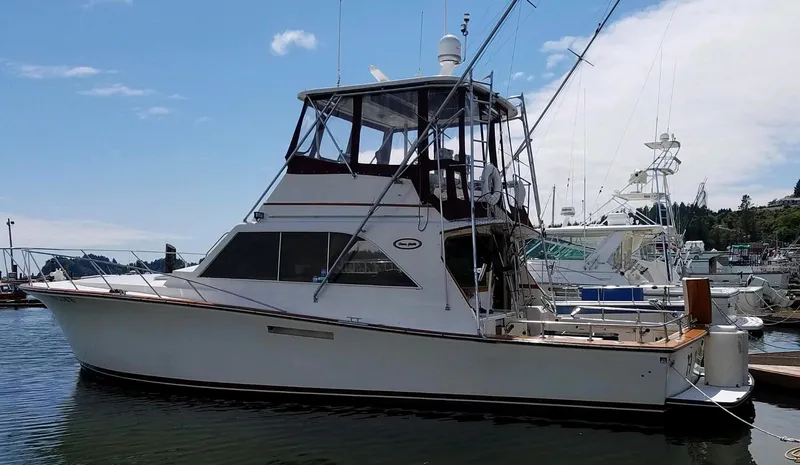 The Image of 1983 Ocean Yachts Super Sport docked at a marina on a sunny day. - 0