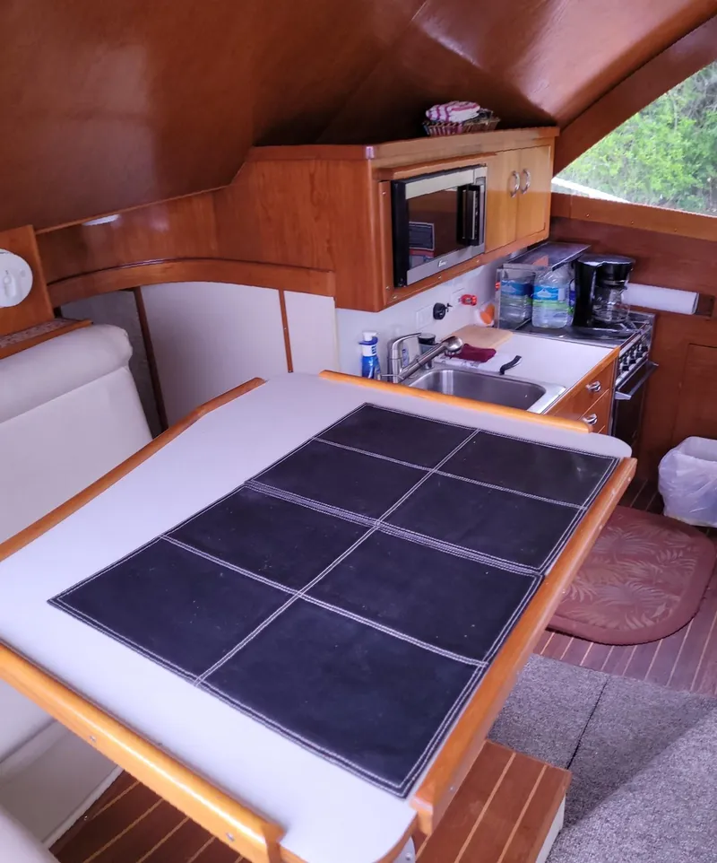 Slide: The Image of Interior of 1983 Ocean Yachts Super Sport with kitchen and dining area. - 9