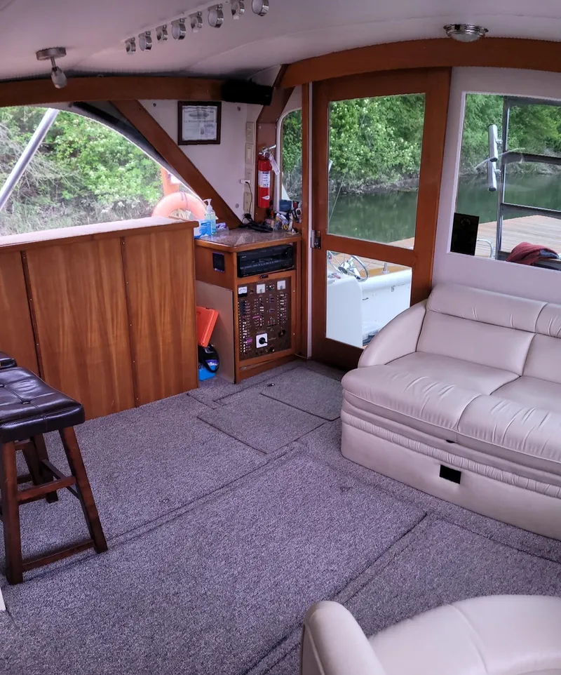 Slide: The Image of Interior of a 1983 Ocean Yachts Super Sport with beige seating and wooden accents. - 10