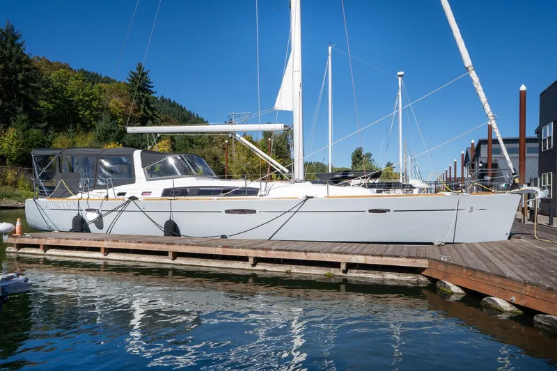 The Image of 2013 Beneteau Oceanis 50 sailboat docked at marina, clear blue sky background. - 1