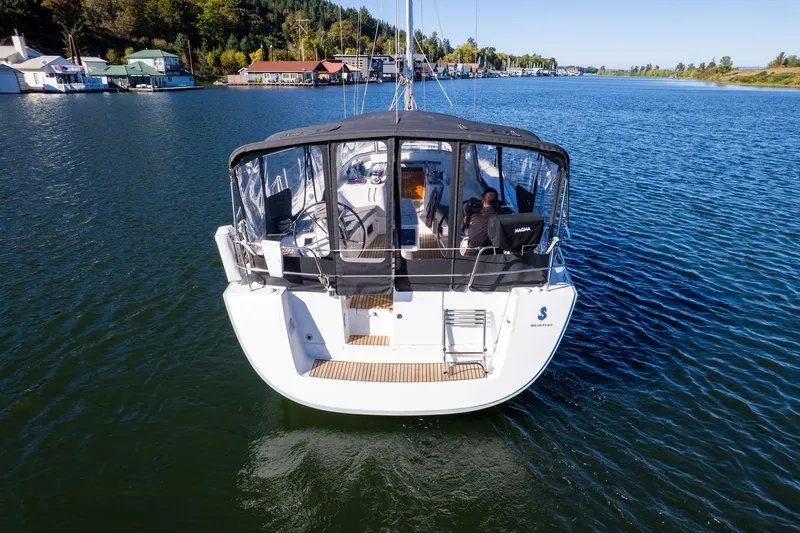 Slide: The Image of 2013 Beneteau Oceanis 50 sailboat on calm water, rear view with covered cockpit. - 3