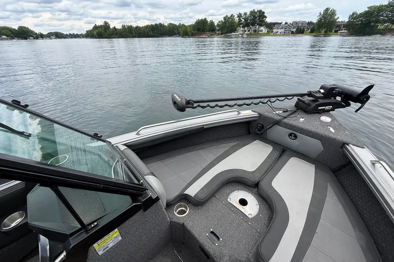 Slide: The Image of 2023 Lund 1975 Tyee boat interior on a calm lake with cloudy sky. - 7