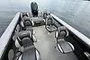 Slide: The Image of 2023 Lund 1975 Tyee boat interior with seating, on calm water. - 2
