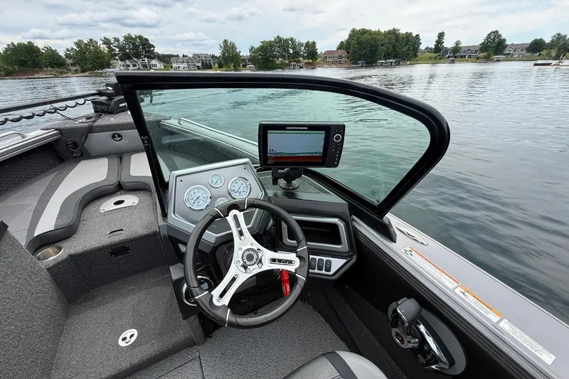 Slide: The Image of Interior view of 2023 Lund 1975 Tyee boat with steering wheel and navigation system. - 5
