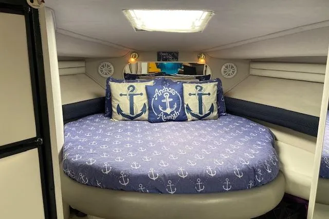 Slide: The Image of Interior of 1994 Cruisers Yachts 3675 Esprit with nautical-themed bedding and anchor pillows. - 11