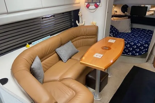 Slide: The Image of Interior of 1994 Cruisers Yachts 3675 Esprit with leather seating and wooden table. - 10