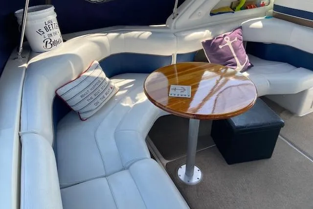 Slide: The Image of Luxurious 1994 Cruisers Yachts 3675 Esprit interior with plush seating and wooden table. - 5