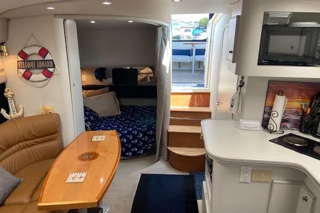 Slide: The Image of Interior of 1994 Cruisers Yachts 3675 Esprit with cozy seating and kitchenette. - 9