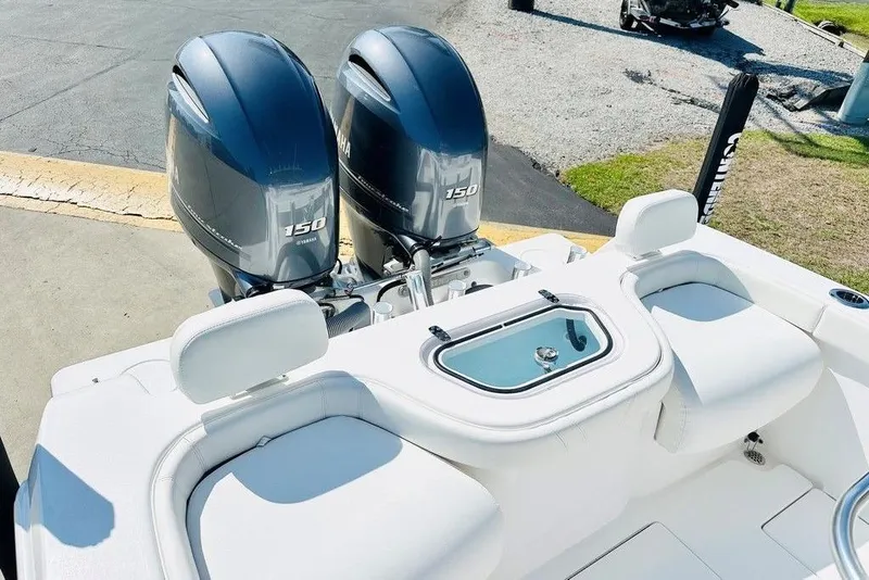Slide: The Image of 2023 Contender 24 Sport boat with dual Yamaha 150 engines, featuring a sleek white deck. - 16