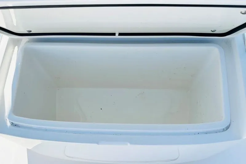 Slide: The Image of Open storage compartment on 2023 Contender 24 Sport boat, showcasing spacious interior. - 10