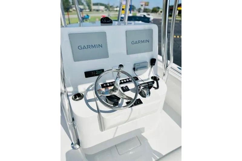 Slide: The Image of 2023 Contender 24 Sport boat console with dual Garmin displays and steering wheel. - 15