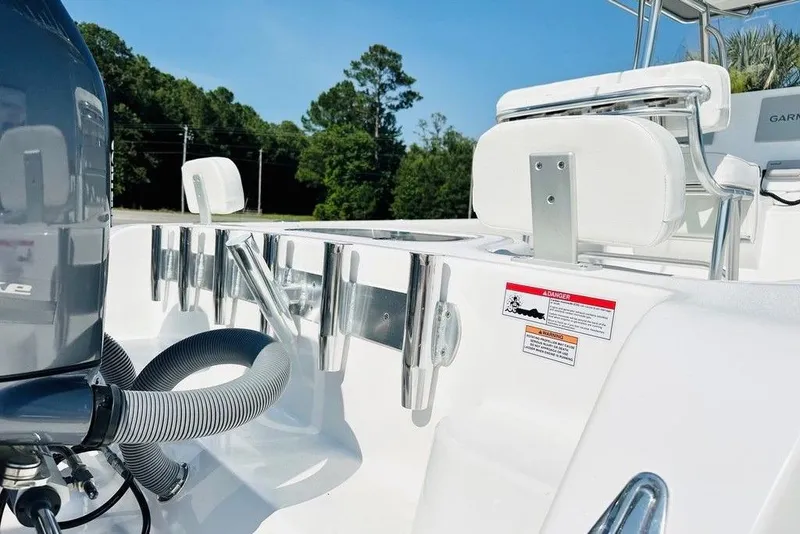 Slide: The Image of 2023 Contender 24 Sport boat interior with engine and seating details. - 18