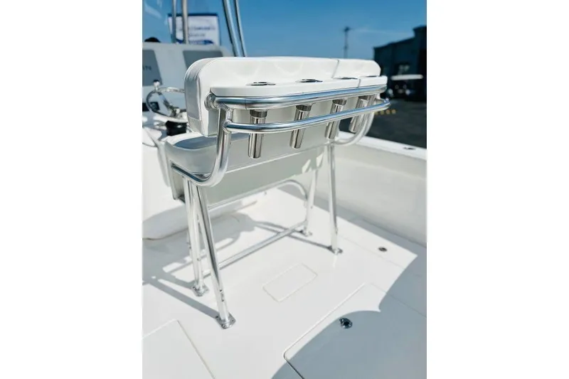Slide: The Image of 2023 Contender 24 Sport boat interior with sleek seating and stainless steel fixtures. - 14