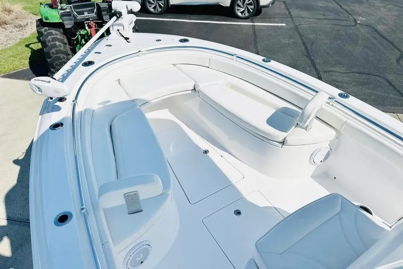 Slide: The Image of 2023 Contender 24 Sport boat interior with white seating and modern design. - 3