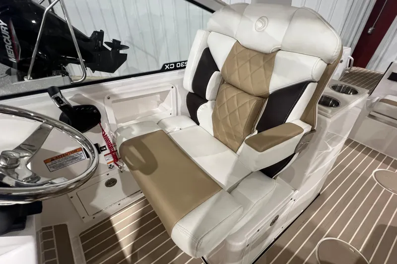 Slide: The Image of 2023 Edgewater 230CX Crossover boat interior with luxurious seating and steering wheel. - 9
