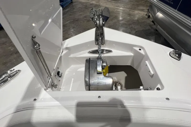 Slide: The Image of Anchor compartment of 2023 Edgewater 230CX Crossover boat, showcasing storage and hardware. - 12