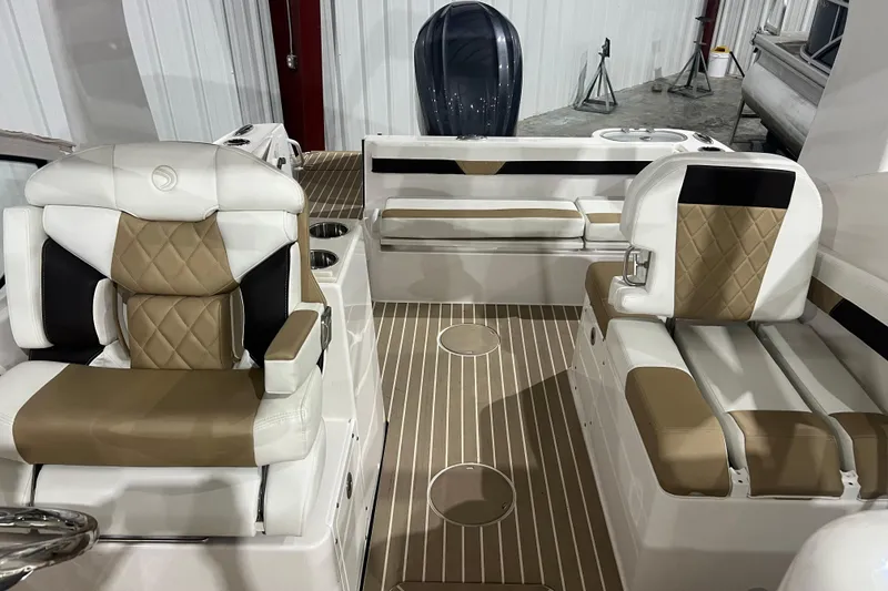 Slide: The Image of 2023 Edgewater 230CX Crossover boat interior with tan and white seating, modern design. - 5