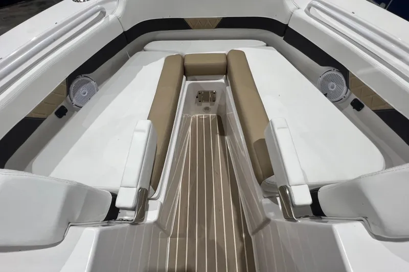 Slide: The Image of Interior of 2023 Edgewater 230CX Crossover boat with cushioned seating and speakers. - 13