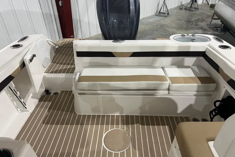Slide: The Image of 2023 Edgewater 230CX Crossover boat interior with cushioned seating and sleek design. - 7