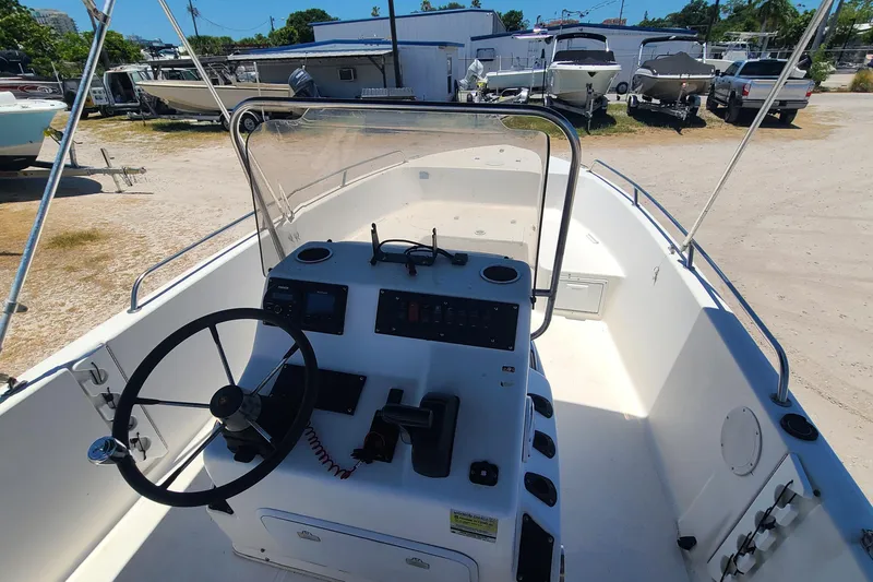 Slide: The Image of 2001 Century 2201 Bay Boat with steering console, parked in a boatyard. - 7