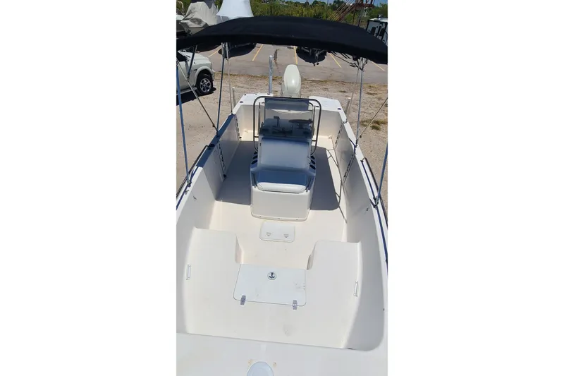 Slide: The Image of 2001 Century 2201 Bay Boat with canopy, spacious deck, and seating, ideal for fishing trips. - 5