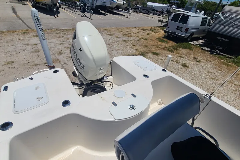 Slide: The Image of 2001 Century 2201 Bay Boat with Suzuki outboard motor in a parking area. - 10