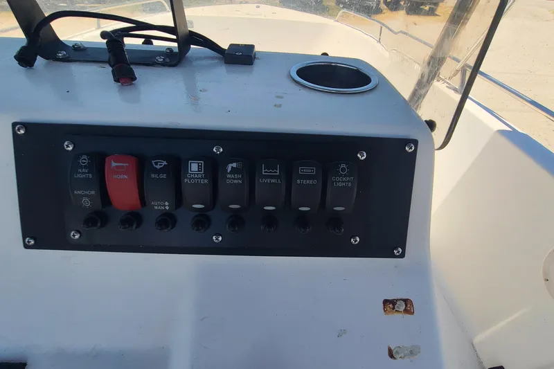 Slide: The Image of Control panel of a 2001 Century 2201 Bay Boat with various switches and buttons. - 9