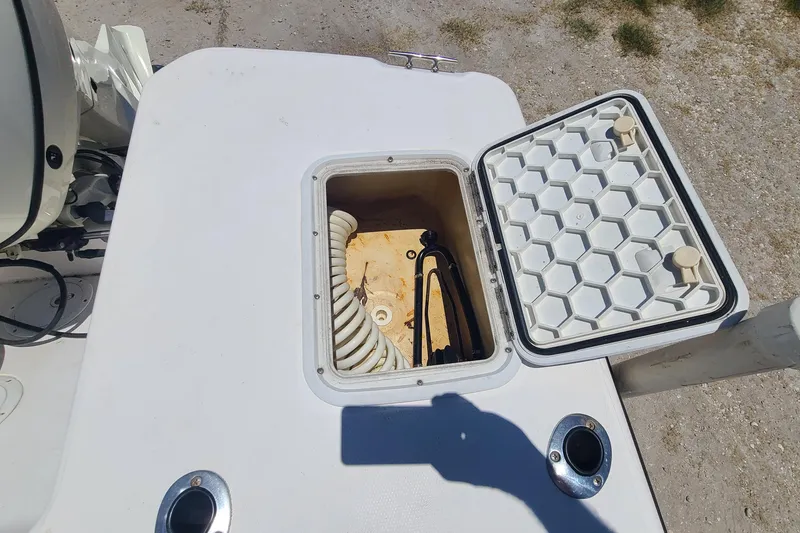 Slide: The Image of Open storage compartment on a 2001 Century 2201 Bay Boat, showing hose and equipment. - 13
