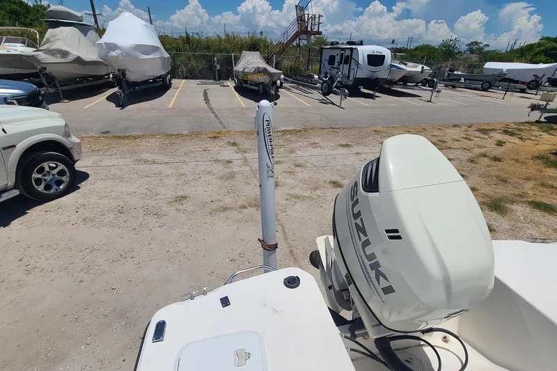 Slide: The Image of Century 2201 Bay Boat 2001 with Suzuki outboard motor in parking lot. - 12