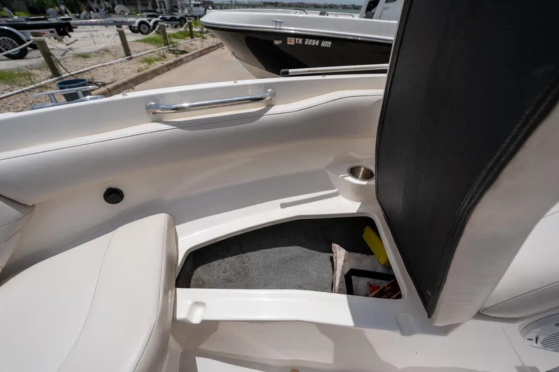 Slide: The Image of Interior of a 2008 Regal 2000 Bowrider boat, featuring seating and cup holder. - 31